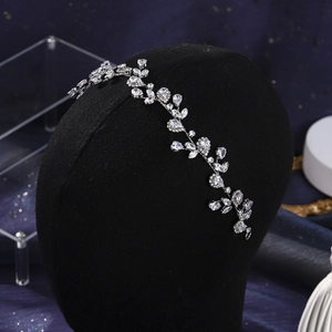 Detailed view of silver vine headband with crystals on a black mannequin model