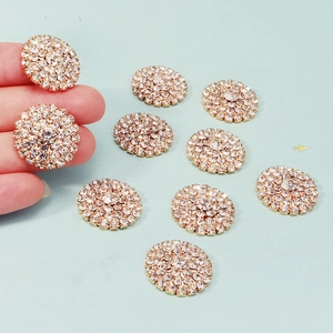 Macro detail of 23mm round sunflower rhinestone buttons with gold base for DIY crafts