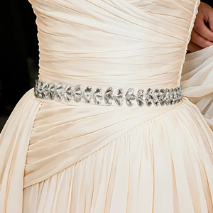 Sparkling crystal bridal belt with silver rhinestones on an off-white wedding dress