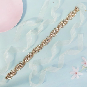 Elegant gold wedding belt featuring handcrafted marquise rhinestones on a blue backdrop