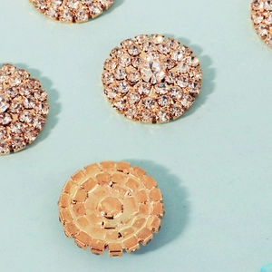 Detailed view of 23mm sunflower crystal rhinestones buttons with polished gold alloy base