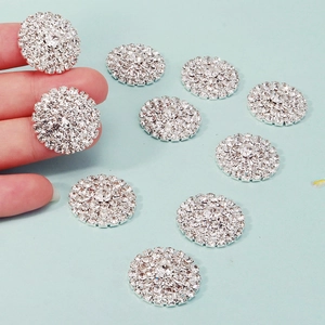 Close-up of 23mm silver sunflower rhinestone buttons for DIY jewelry making and crafts