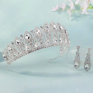 Detail of silver bridal tiara and teardrop earrings set with sparkling crystals