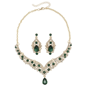 Close-up of gold-plated V-shaped necklace and drop earrings set with green teardrop crystals