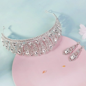Detailed close-up of bridal jewelry set with silver tiara and teardrop earrings