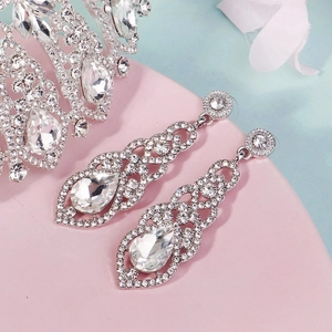 Detail of silver bridal jewelry set with sparkling teardrop crystals and tiara crown
