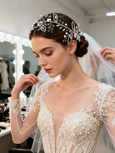 Detail of bridal headband with silver leaf vine pearls and rhinestones on lace wedding dress