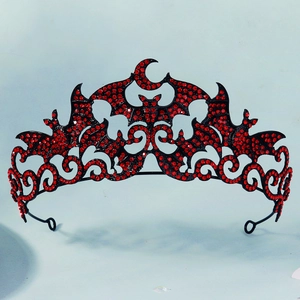 Close-up of Gothic bat crown with red rhinestones and crescent moon on black metal