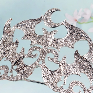 Macro shot of silver bat crown with crescent moon and sparkling rhinestones for Halloween
