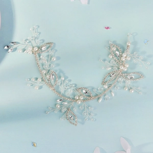 Detail view of handmade bridal hair vine with silver leaves, white pearls and crystals