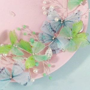 Detail of handmade fairy hair vine with light green tulle butterflies and pearls