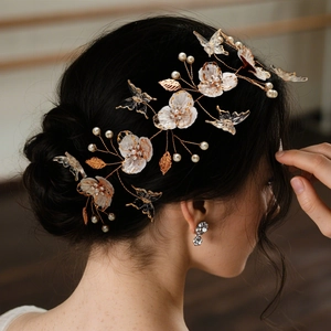 Elegant bridal hair vine with white flowers and pearls on golden wire for weddings