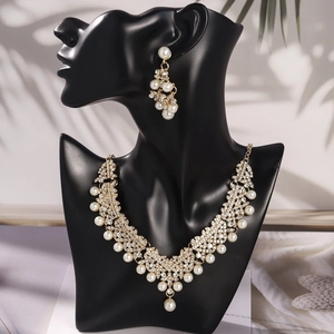 Detail view of gold bridal jewelry set with sparkling rhinestones and elegant pearls