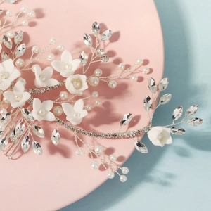 Detail of bridal hair comb with handmade ceramic flowers, pearls and crystal accents