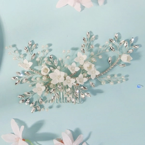 Detailed view of handmade silver floral hair comb with pearls and rhinestones for brides
