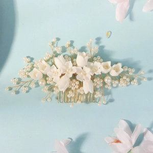 Elegant white floral hair comb with resin petals and pearls for bridal wedding styling