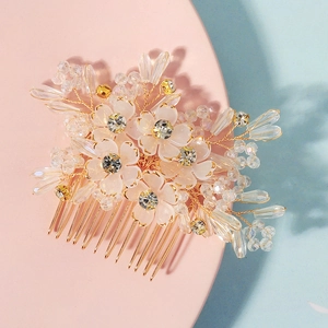Detail of handmade wedding hair comb with crystal beads and white resin flowers