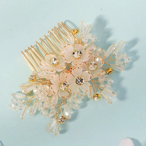Detail of handmade crystal flower hair comb with golden beads and rhinestones
