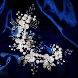 Détail de la vigne de cheveux de mariée avec fleurs blanches et perles sur soie bleue