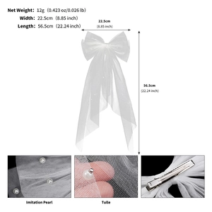 Detail of white bridal tulle bow hair clip with imitation pearls and spring clip back