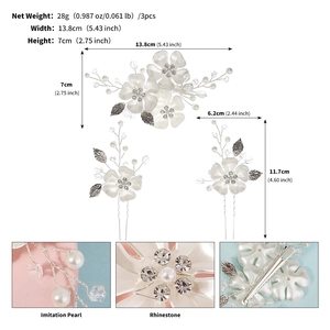 Detail of white resin floral hair pins set with pearls and rhinestones for bridal hairstyle