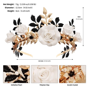 Detail showing white clay roses and black metal leaves with measurements on a crown
