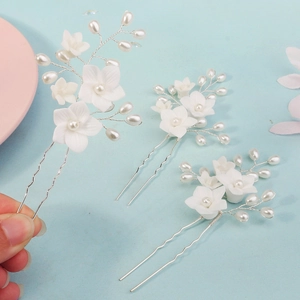 Handmade bridal hair pins set featuring white resin flowers and pearls on silver wire