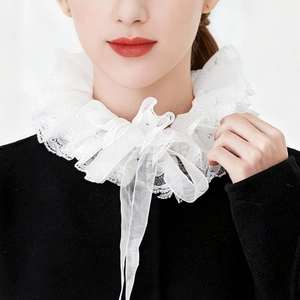 Detail of multi-layered white lace ruffles and ribbon bow on circus clown choker neck collar