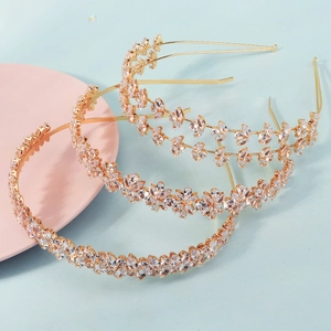 Elegant gold bridal headbands with shimmering marquise crystals and floral vine patterns
