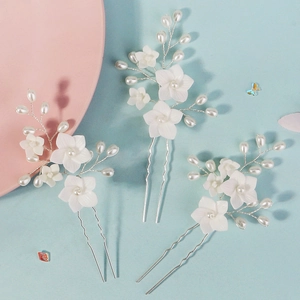 U-shaped bridal hair pins with white resin flowers and pearls for wedding hairstyles