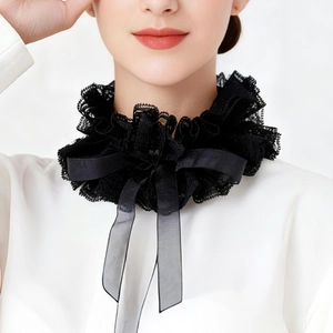 Detail of black lace ruffle neck collar with a large decorative bow in vintage royal style