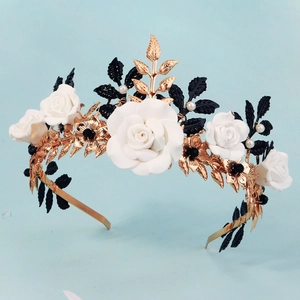 Detailed view of handmade gold floral crown with white roses and pearl accents