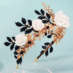 Elegant gold bridal headband with white ceramic roses and decorative black leaves