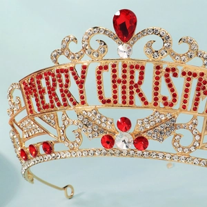 Close-up of golden Christmas crown with red rhinestones and Merry Christmas text