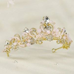 Detail of pink crystal bridal crown with rhinestones on a textured gold alloy frame