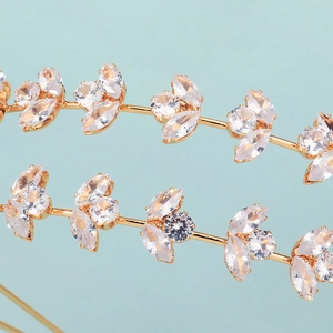 Detail of elegant gold leaf headband featuring marquise cut zircon and leaf branch design