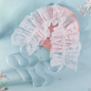 Detailed view of layered white lace circus collar with elegant satin ribbons and frills
