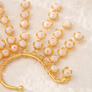 Elegant gold lily of the valley ear cuff with handmade wire wrap and crystal beads