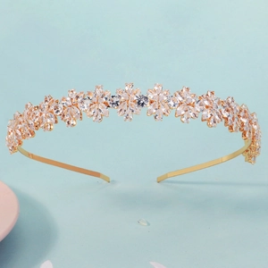 Detailed macro view of golden tiara featuring sparkling marquise zircon floral patterns