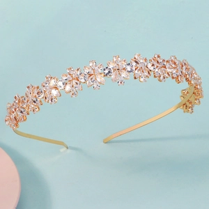 Detail of luxury gold headband featuring intricate cubic zirconia floral patterns