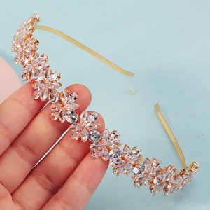 Detailed close-up of golden marquise-cut zircon flowers on bridal headband accessory