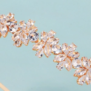 Detailed close-up of crystal zircon flowers on golden headband with marquise cut stones