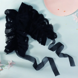 Close-up of black lace circus collar ruff with delicate pleated design and long ribbons