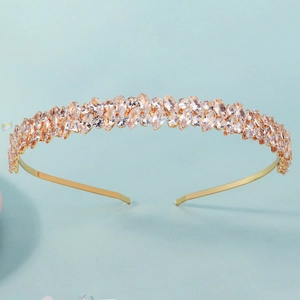 Detailed close-up of a gold bridal headband featuring luxury marquise-cut crystal rhinestones