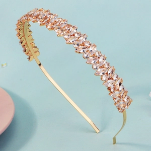 Detailed view of champagne marquise crystals set on a slim golden headband for parties