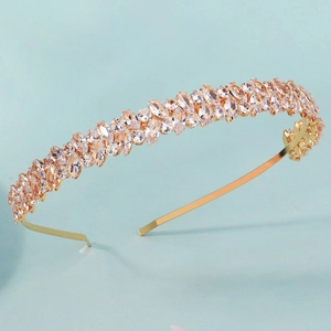 Detail of luxury gold headband featuring marquise cut marquise crystals on blue fabric