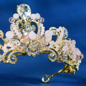 Exquisite golden bridal crown with pink crystals and rhinestones for wedding parties