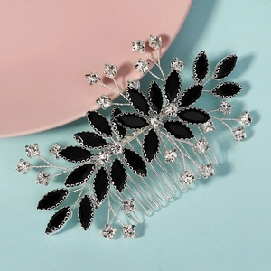 Close-up of floral hair comb featuring black marquise stones and sparkling rhinestones