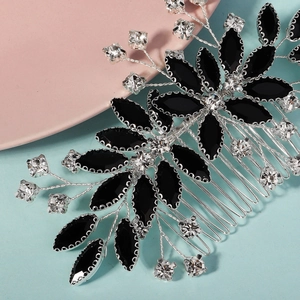 Macro detail of handmade bridal hair comb with black marquise stones and crystals