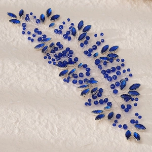 Detail of silver wire bridal hair vine with navy blue crystals and beads on paper